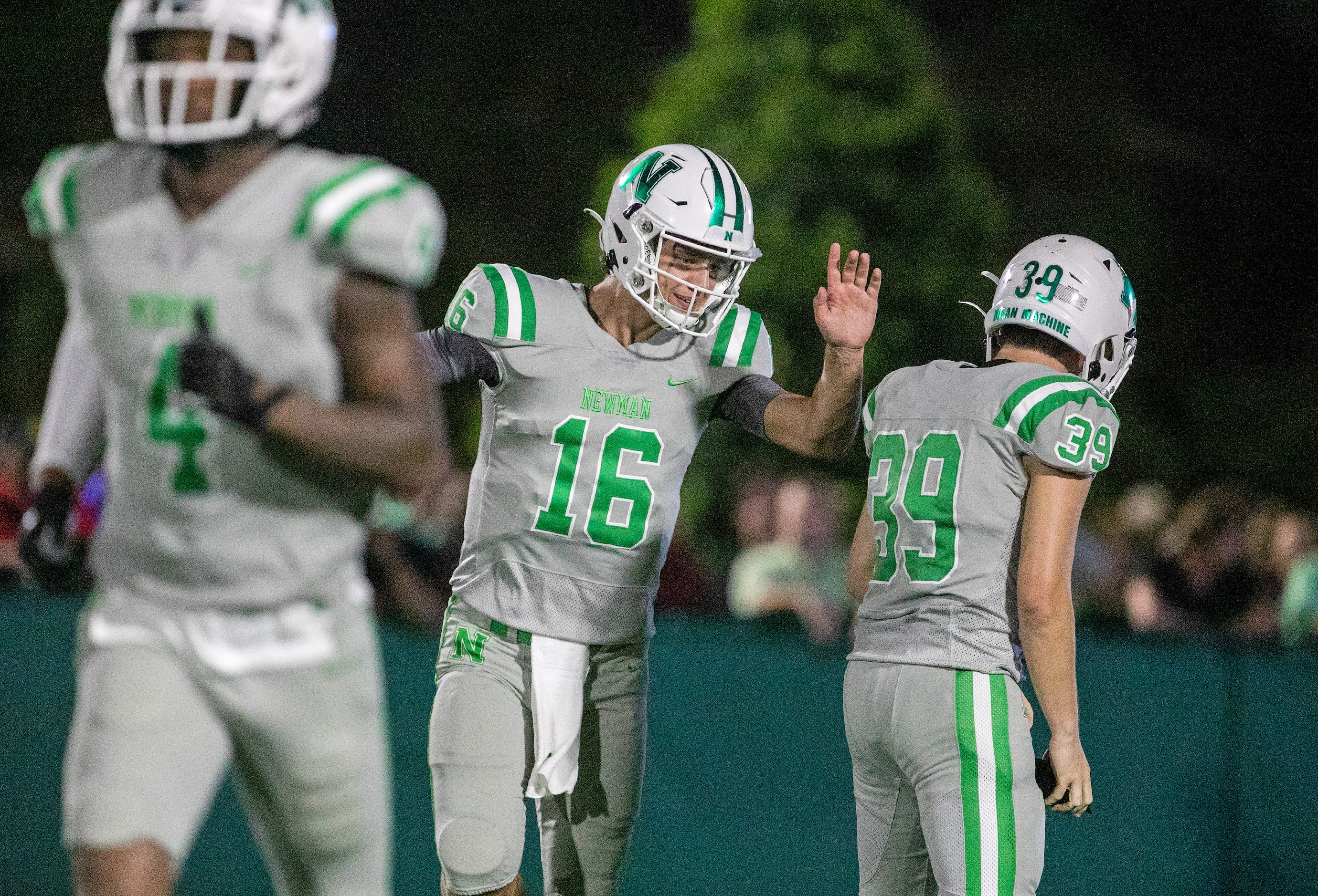 Arch Manning congratulates teammate (39) as Newman High School takes on Riverside Academy...