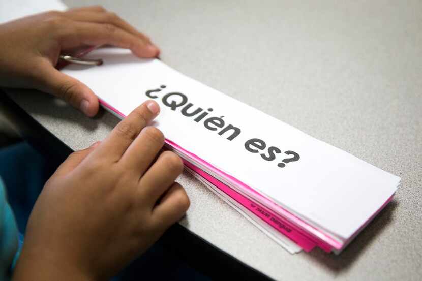 A student works on question phrases in a bilingual classroom.