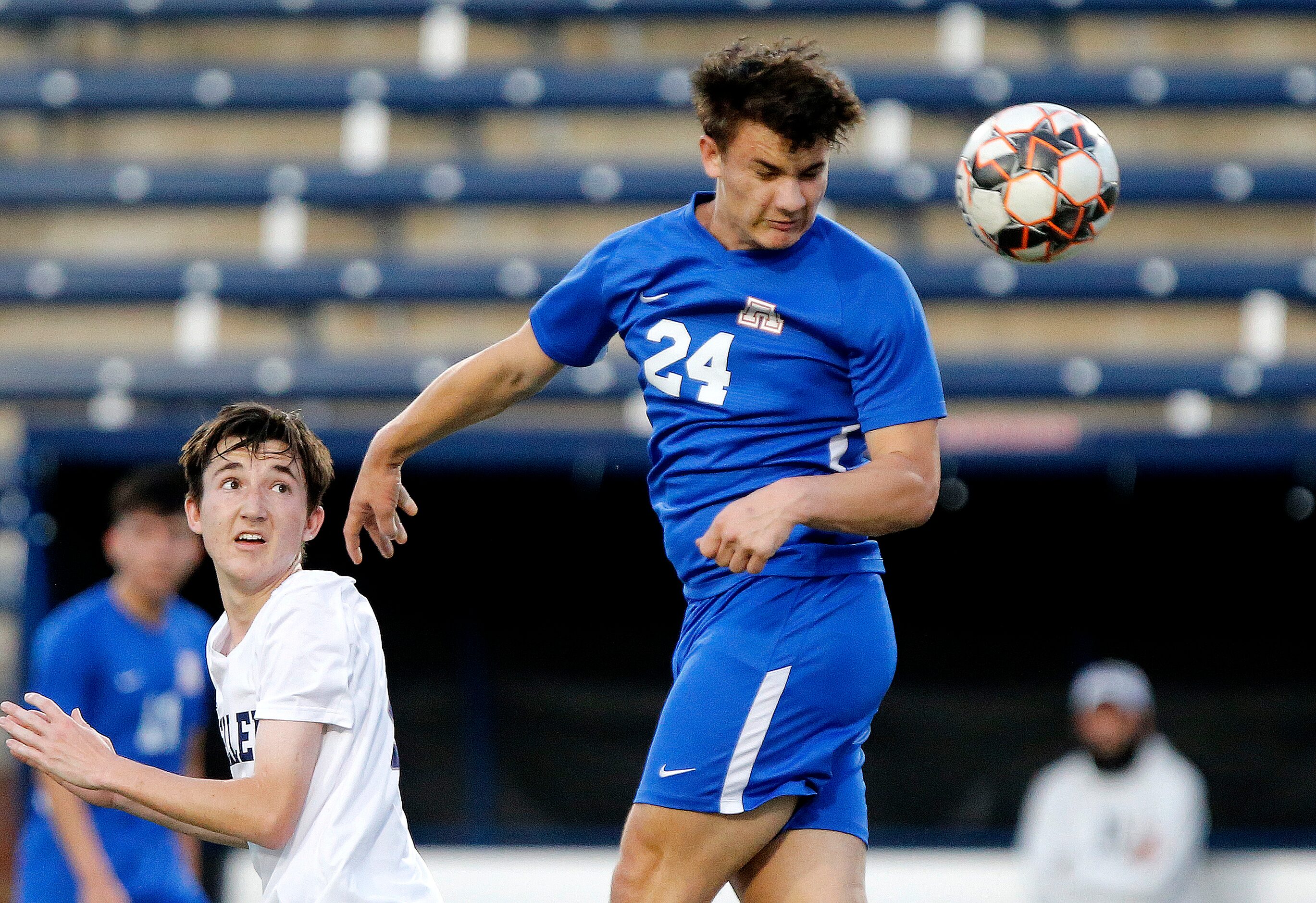 Allen forward Brendan Pipher (24) gets a header during the first half as Allen High School...