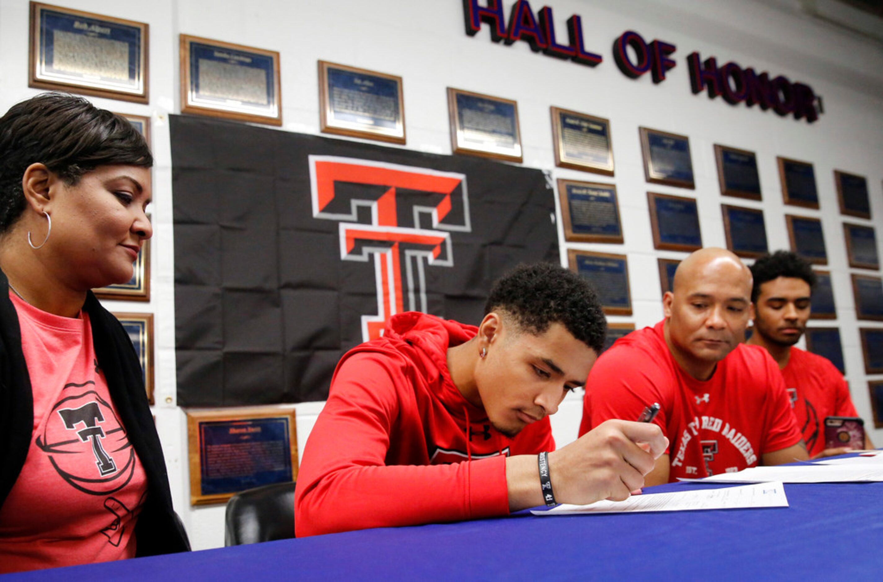 Alongside his parents, Tamara Peavy (left) and head coach David Peavy (second from right),...