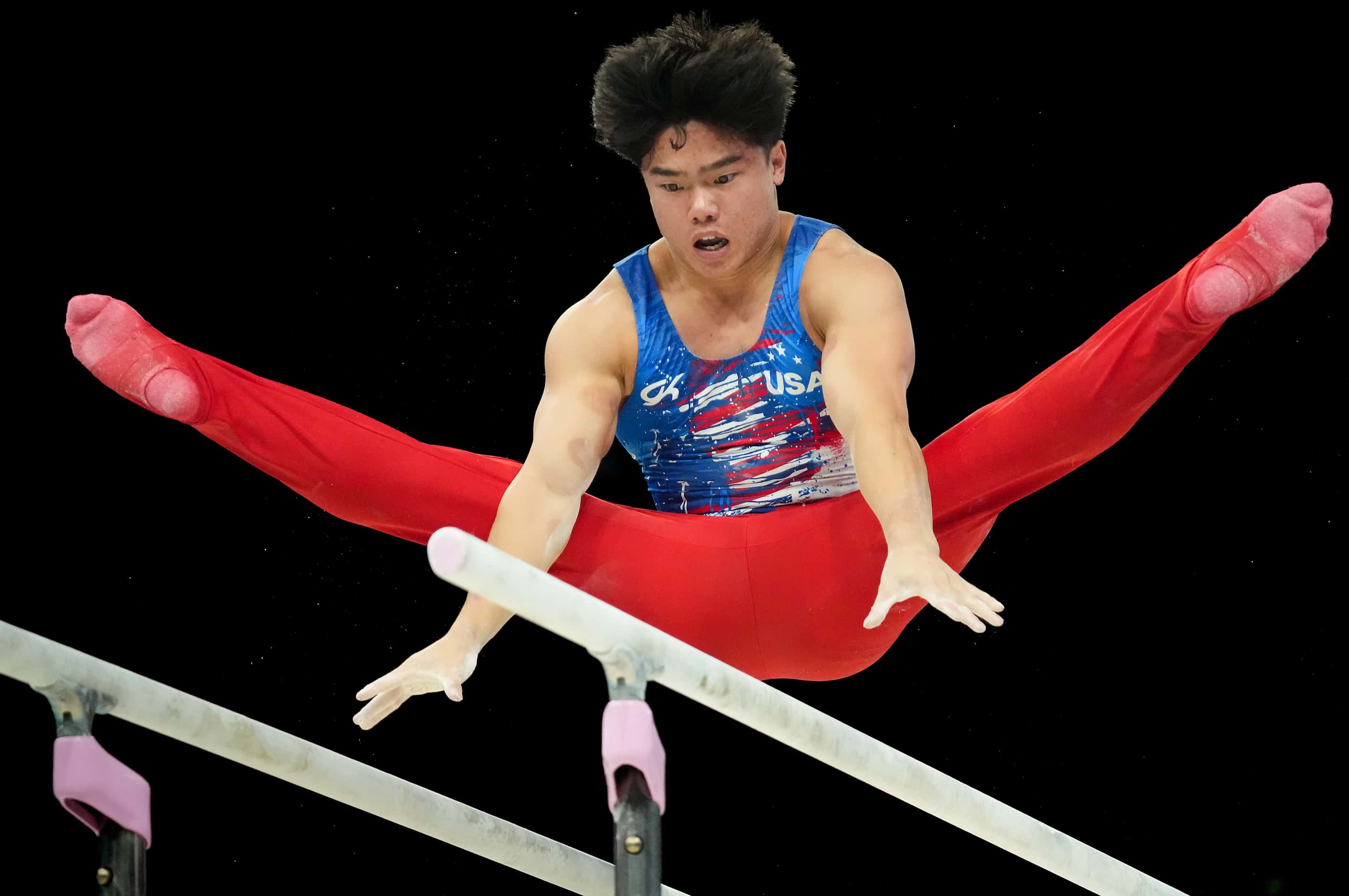 Asher Hong of the United States competes on the parallel bars during men’s gymnastics...
