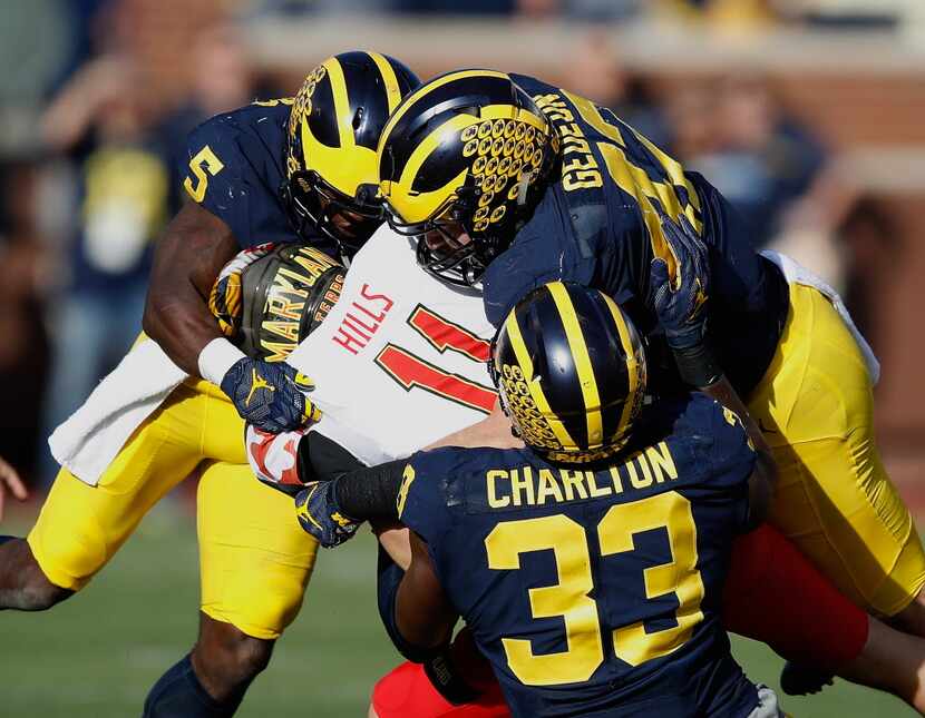 ANN ARBOR, MI - NOVEMBER 05: Perry Hills #11 of the Maryland Terrapins is tackled in the...