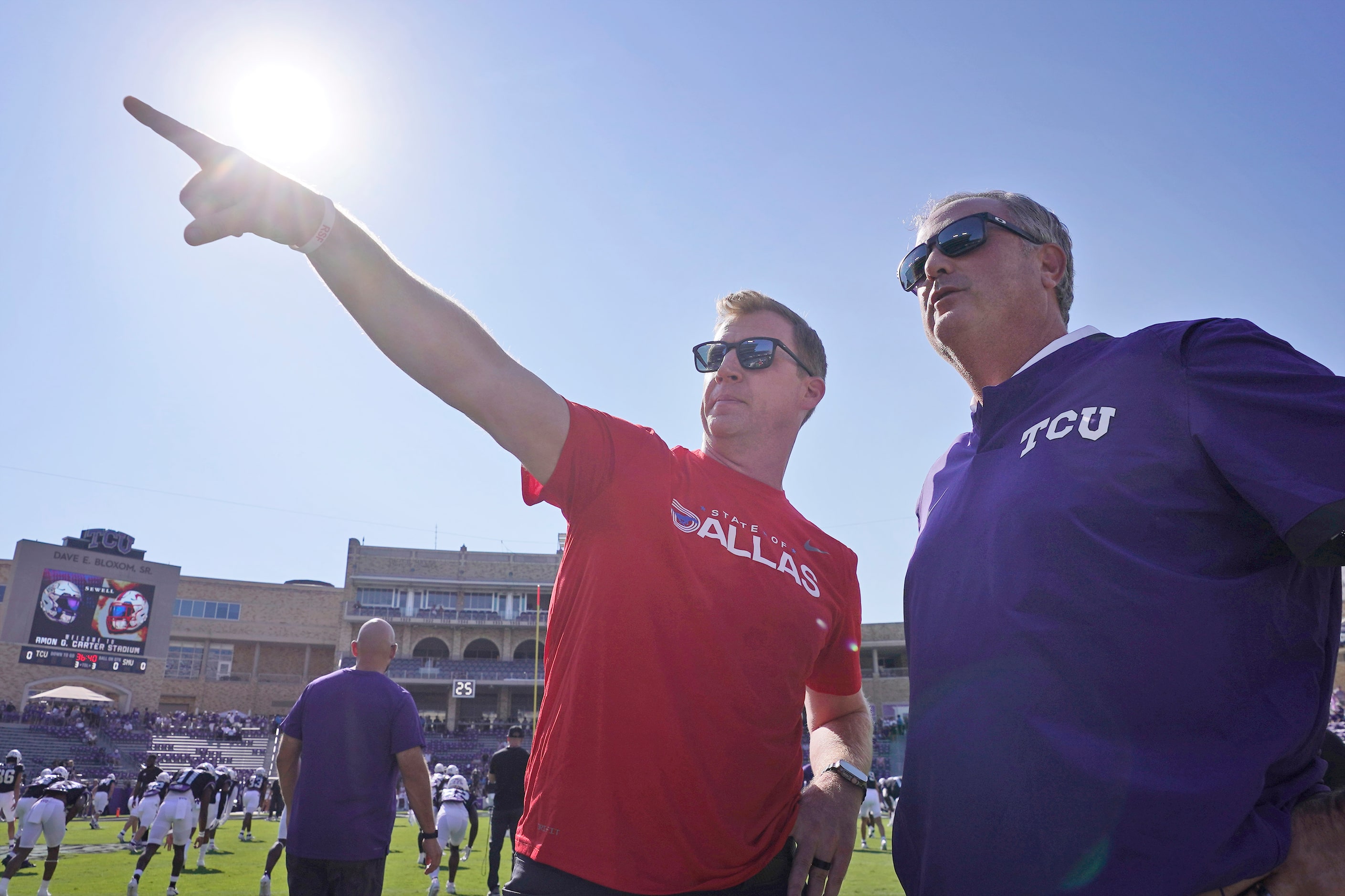 SMU head coach Rhett Lashlee, left, and TCU head coach Sonny Dykes chat during warmups...