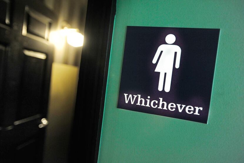 
This gender neutral sign posted outside restaurant bathrooms illustrates one way businesses...