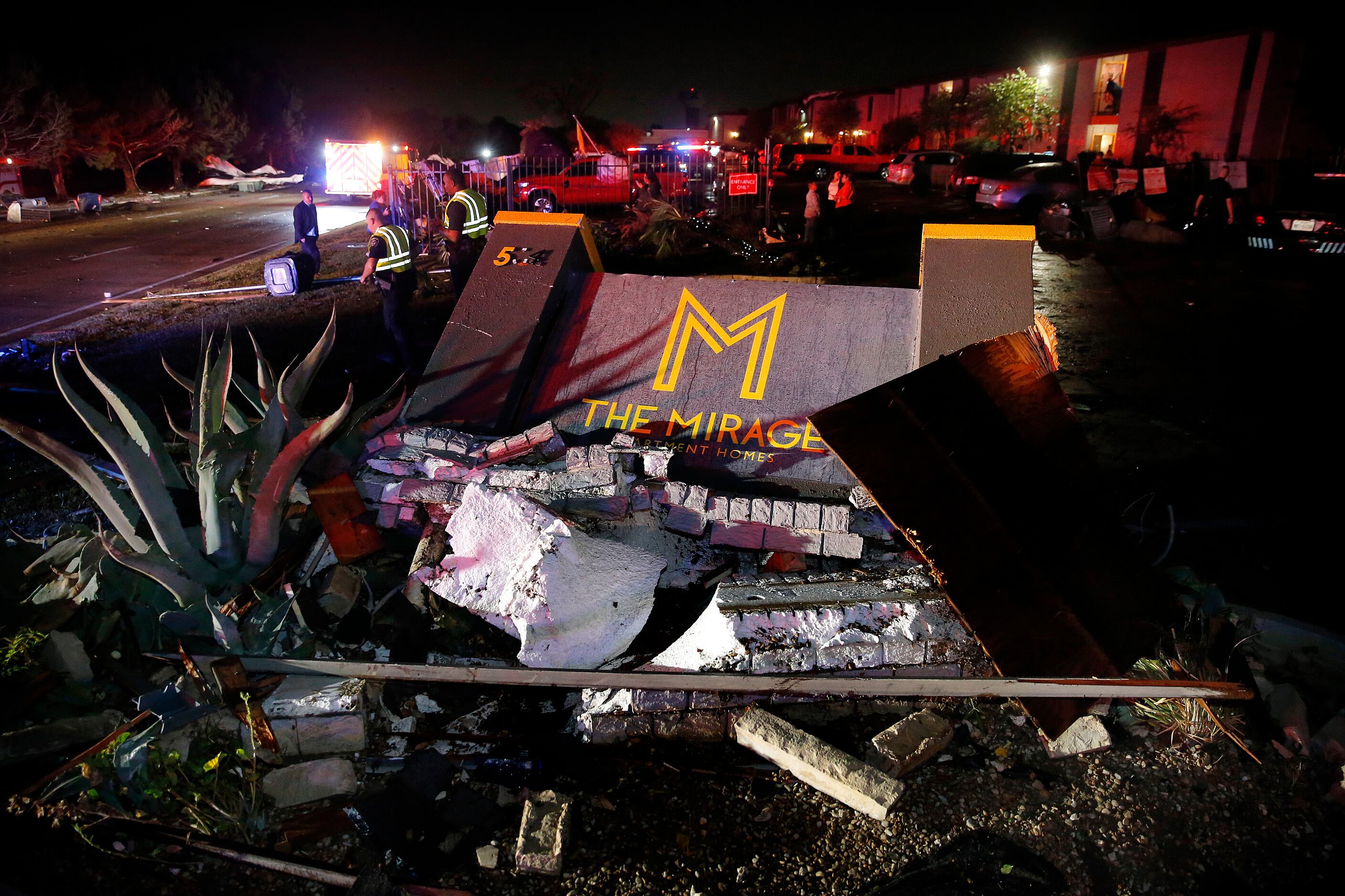 The Mirage Apartments sign lies damaged along Pioneer Parkway in Arlington following a...