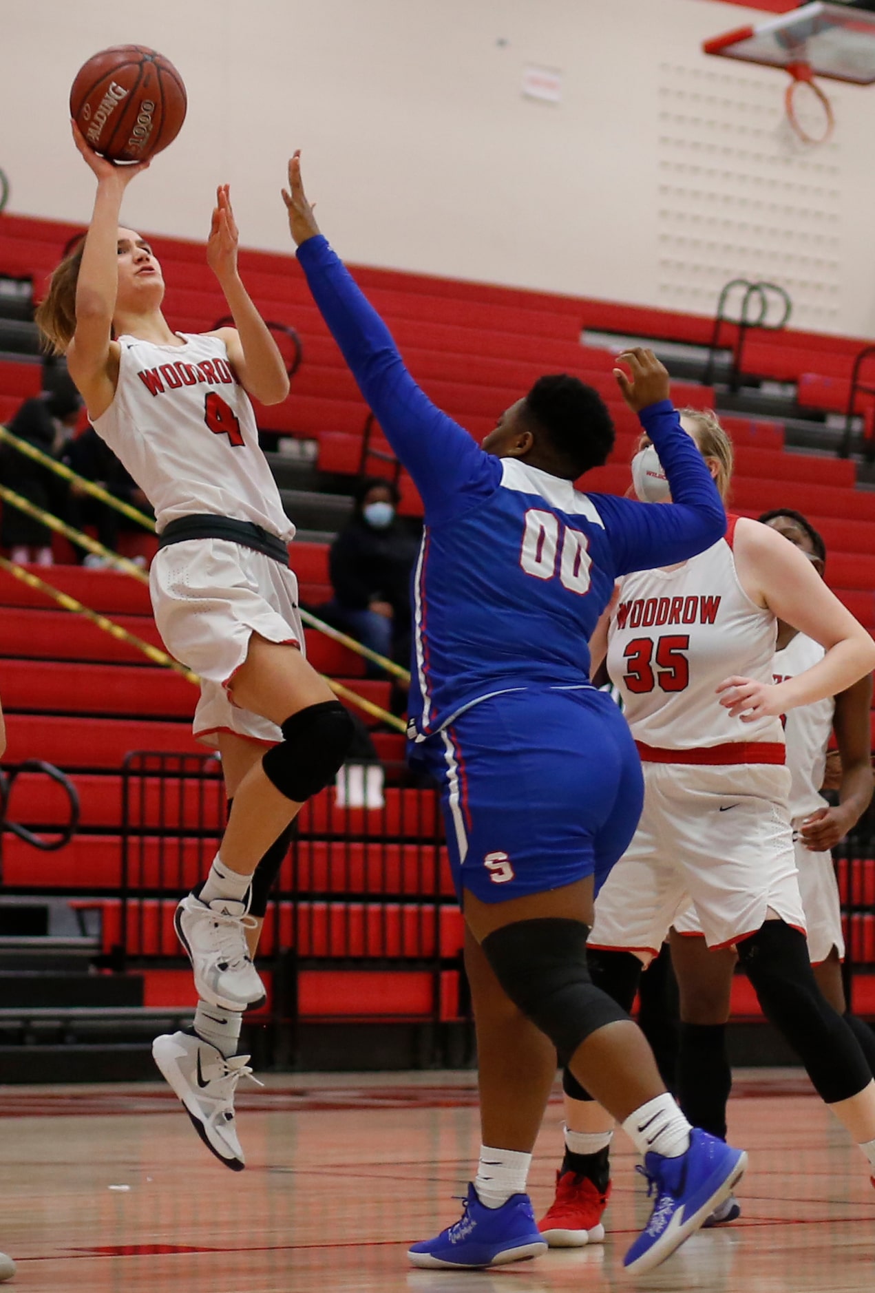 Dallas Woodrow Wilson's Ellery Sample (4) puts up a shot over the defense of Dallas Spruce...