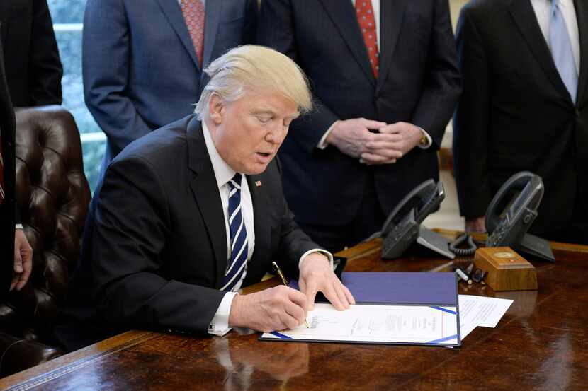 U.S. President Donald Trump signs H.J. Res 41, which disapproves a rule mandated by the...