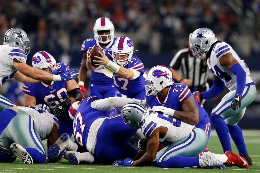 Buffalo Bills quarterback Josh Allen (17) dives for a first down in a game against the...