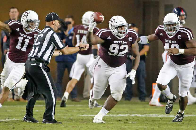 Texas A&M Aggies defensive lineman Zaycoven Henderson (92) celebrates with teammates as he...