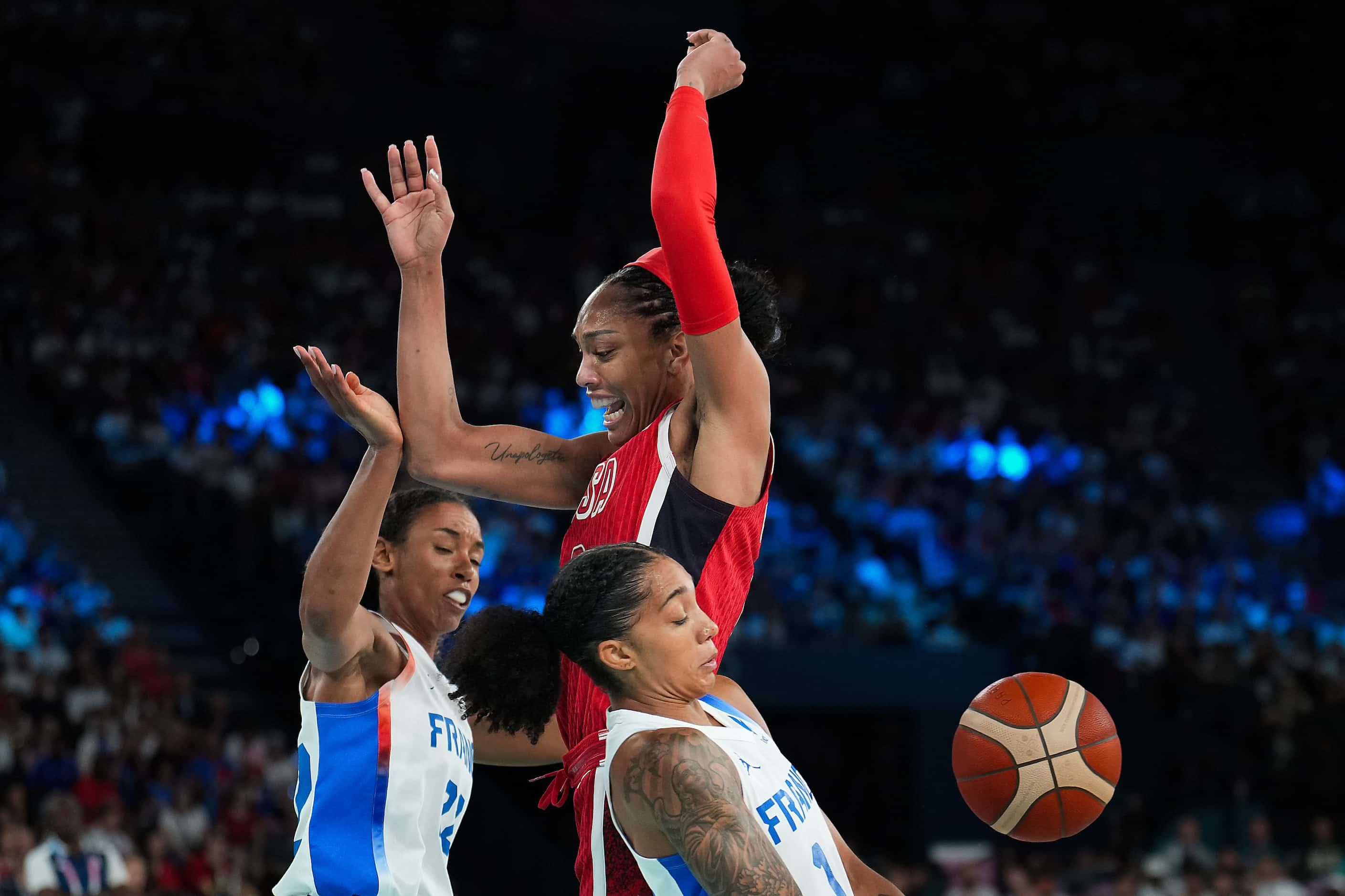 A'Ja Wilson (9) of the United States has the ball knocked away as she tries to drive between...