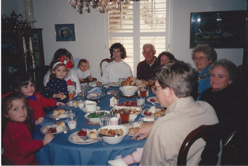Nanette Light (front left), then age 6, sits around the dining room table in 1993 with her...
