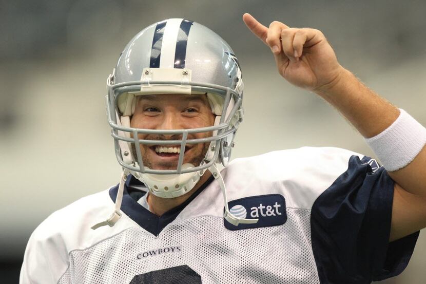 Quarterback Tony Romo (9) is all smiles during Dallas Cowboys training camp at Cowboys...