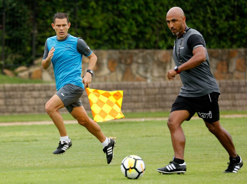 CONCACAF soccer assistant referee William Arrieta of Costa Rica (left) watches to see if...