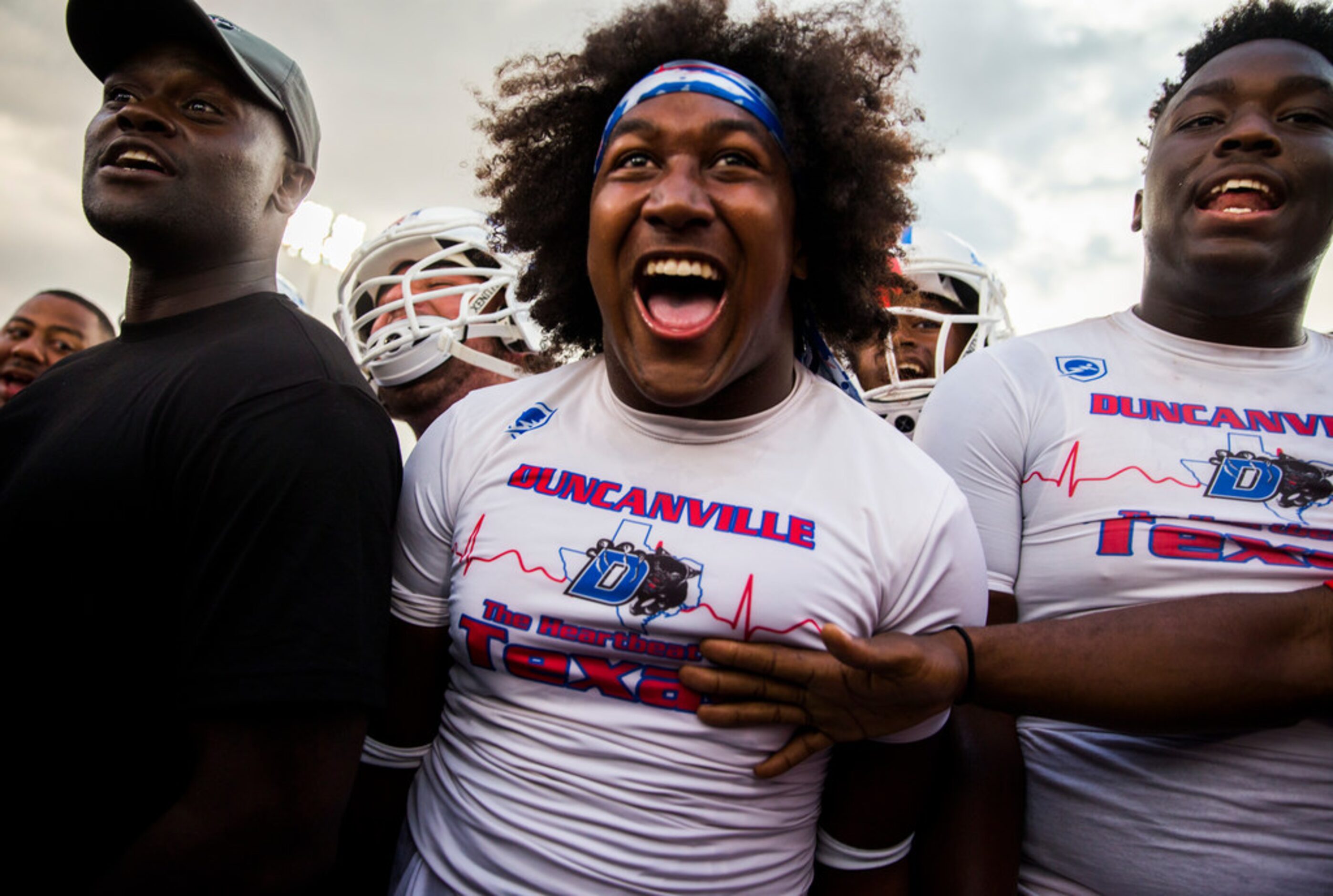 Duncanville linebacker Amari Wynn (52, center) and other football players trash talk Skyline...