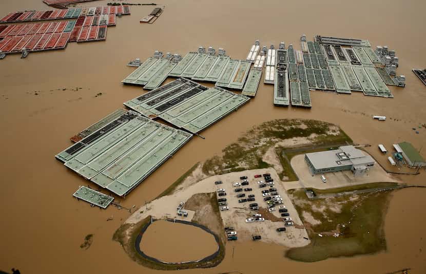 Barges are secured by tugboats in the flood swollen Burnet Bay along the Houston Ship...