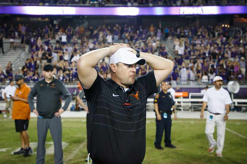 Texas head coach Tom Herman holds his hands on his head following a loss to TCU in an NCAA...
