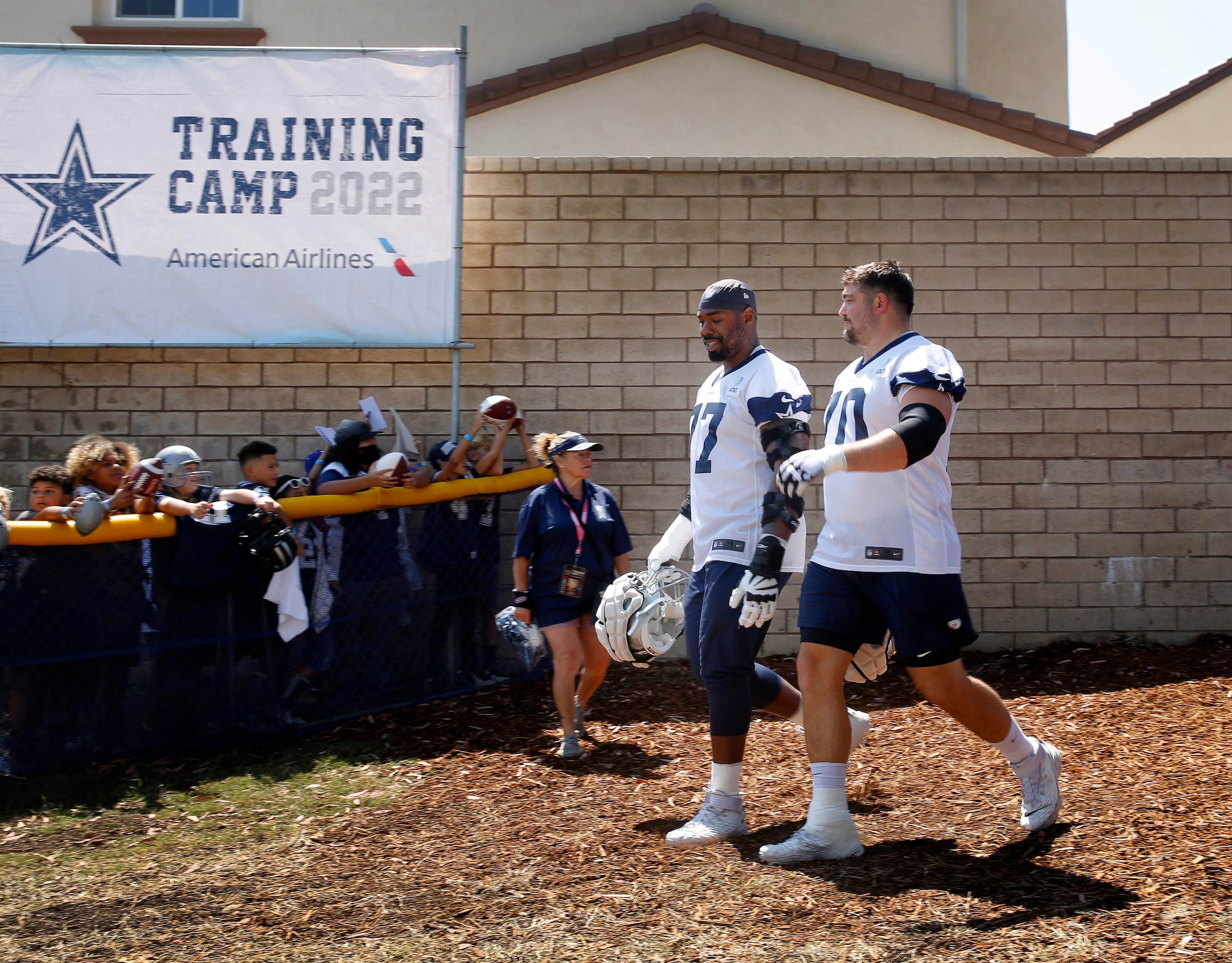 Dallas Cowboys offensive tackle Tyron Smith (77) and offensive guard Zack Martin (70) walk...