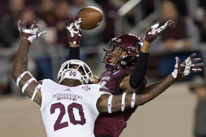 Texas A&M defensive back Charles Oliver (21) breaks up a pass intended for Mississippi State...