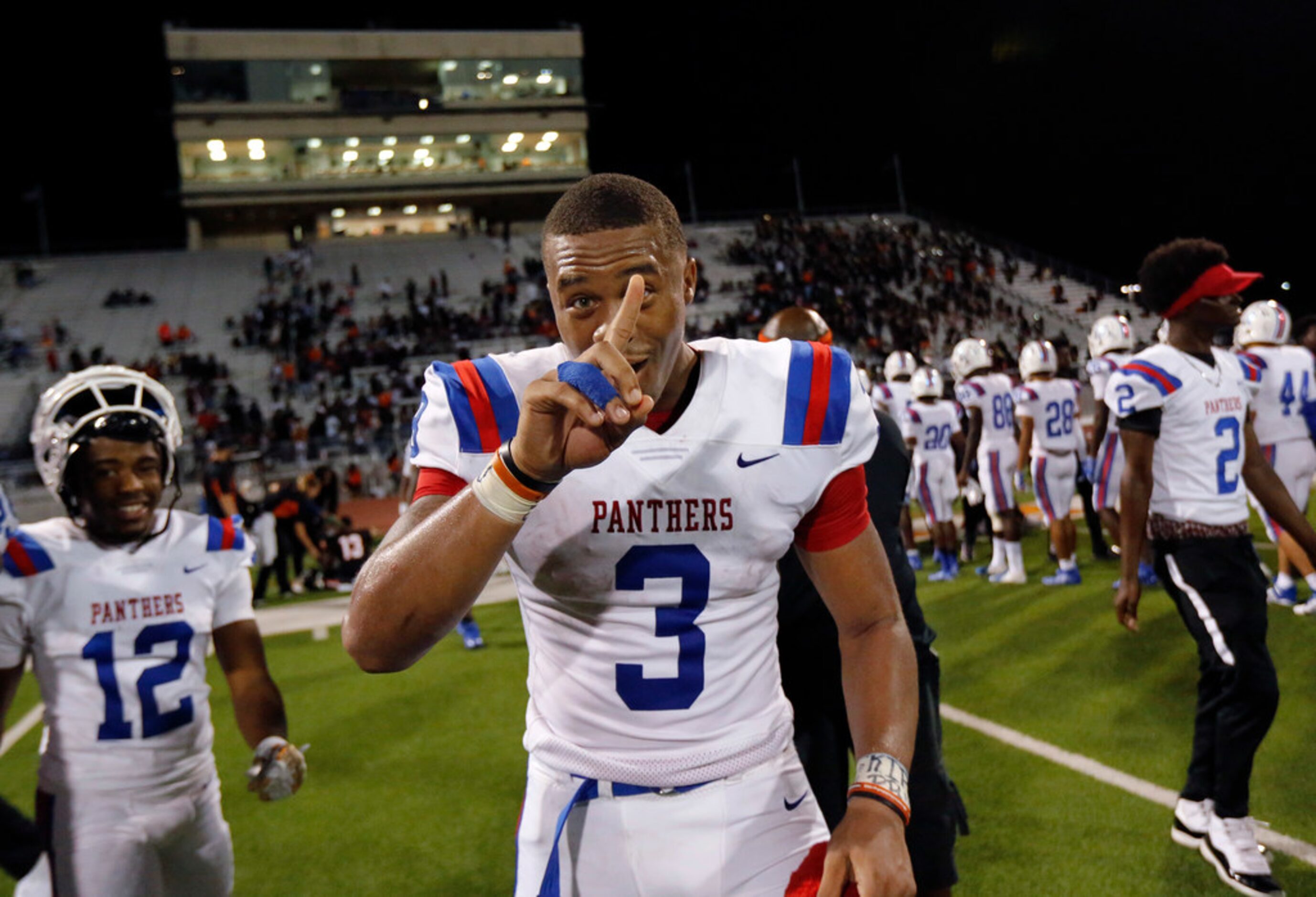 Duncanville quarterback Ja'Quinden Jackson flashes a number 1 after he and his teammates...