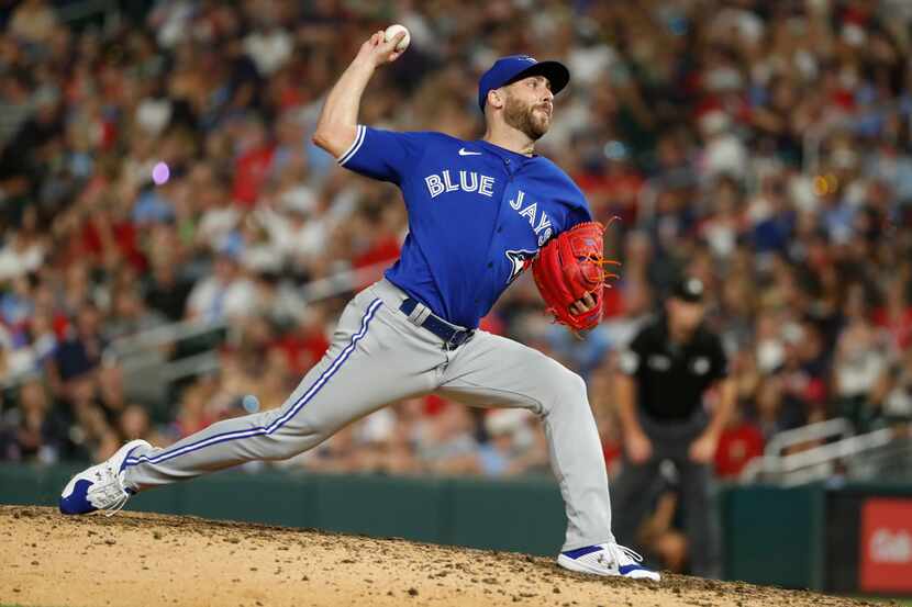 FILE -Toronto Blue Jays relief pitcher Anthony Bass throws to a Minnesota Twins batter...