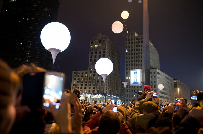 Balloons of the art installation 'Lichtgrenze 2014' fly away at Potsdamer Platz to...