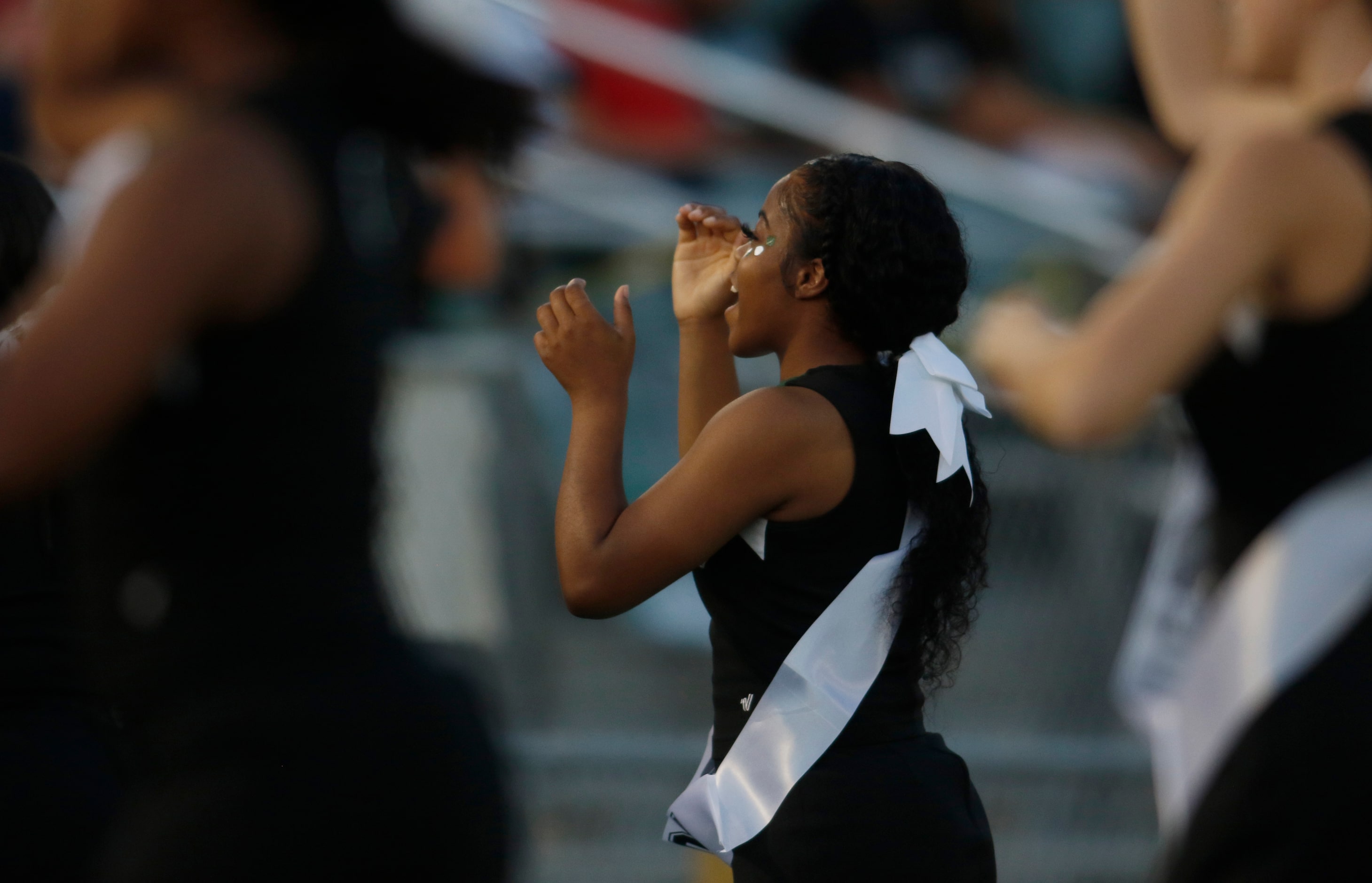 Members of the Kennedale cheerleaders lead fans in a cheer during first half action against...