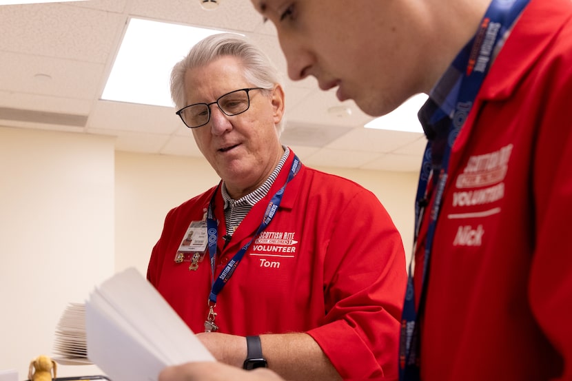 Tom Shehan (left) and Nick Bloczynski sort and process mail at the Scottish Rite Hospital...