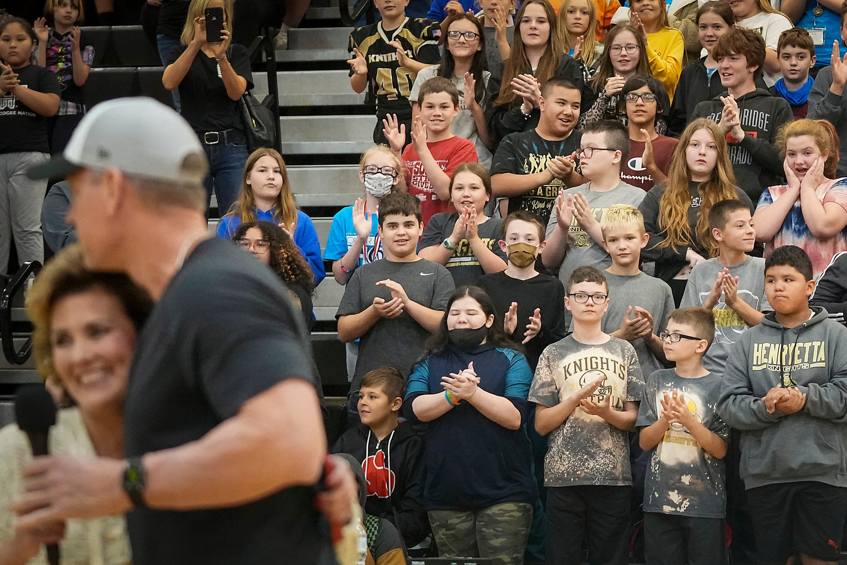 Elementary and middle school students applaud as Troy Aikman is introduced by mayor Jennifer...