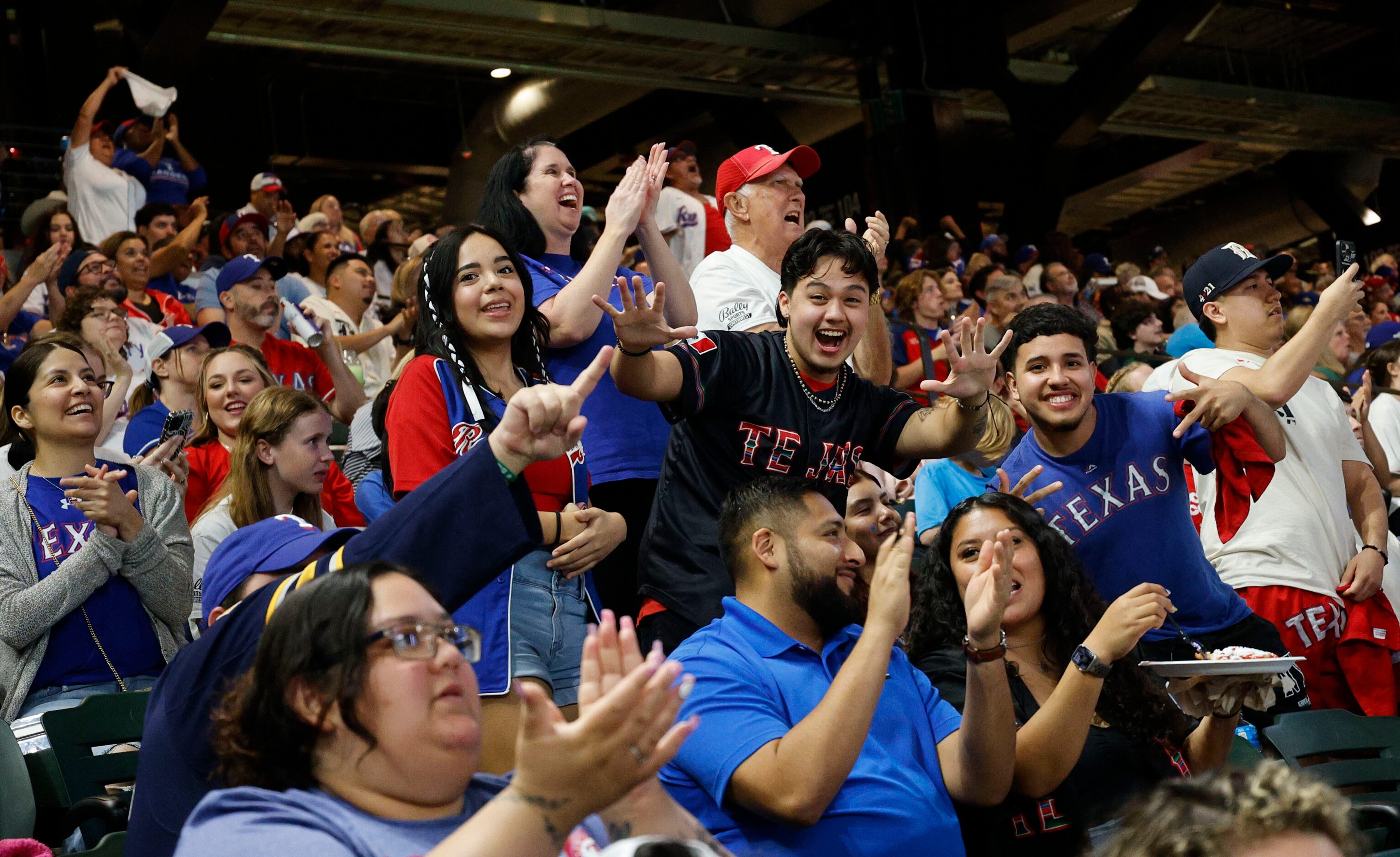 Texas Rangers fans react during a Game 7 watch party of the baseball American League...