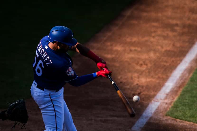 Texas Rangers catcher Tony Sanchez bats during the sixth inning of a spring training...