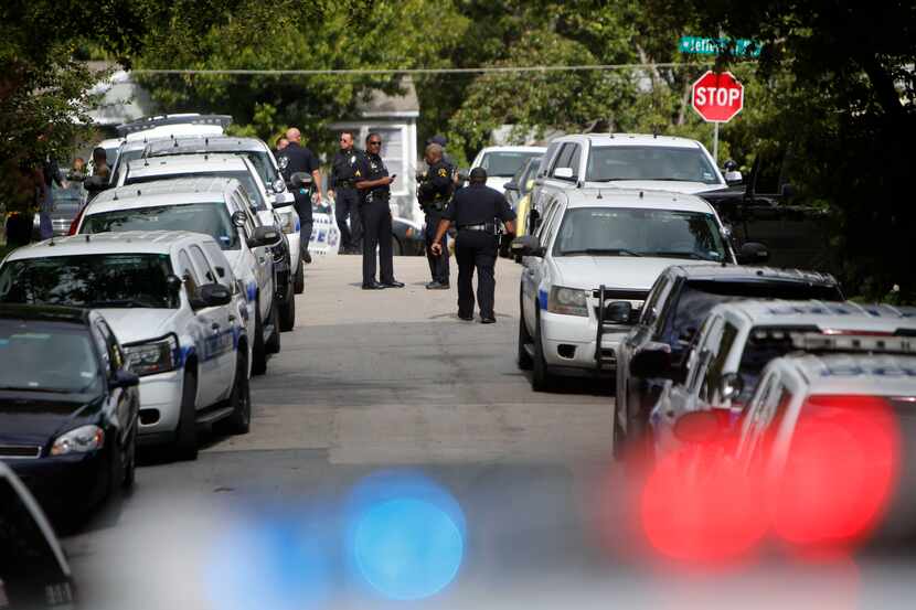 Dallas police officers filled Irwindell Boulevard in west Oak Cliff near a home in the 3500...