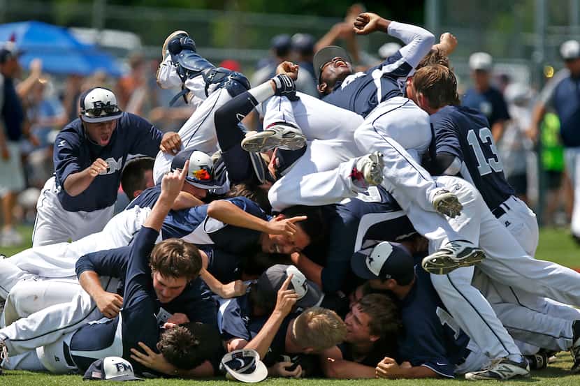 The Flower Mound High School baseball team piles ontop of each other in celebration after...