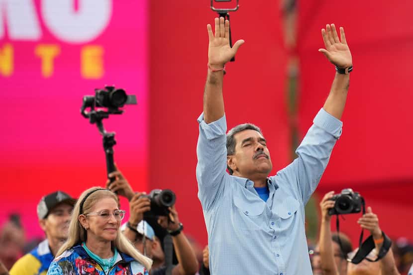 President Nicolas Maduro raises his hands during his closing election campaign rally in...