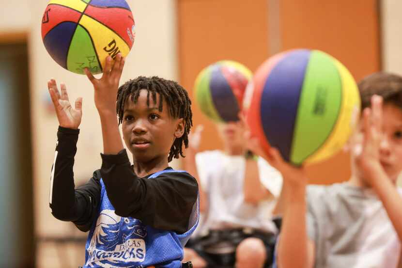 Kayden Garratt, 10, warms up his fingers during a drill at Family Life Center at Trietsch...