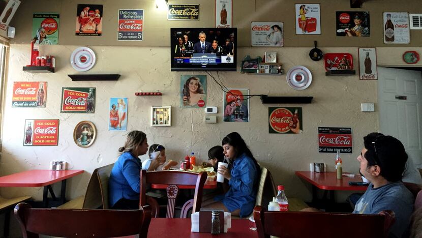 A family ate lunch at Aca Las Tortas in East Dallas on Tuesday as President Barack Obama...