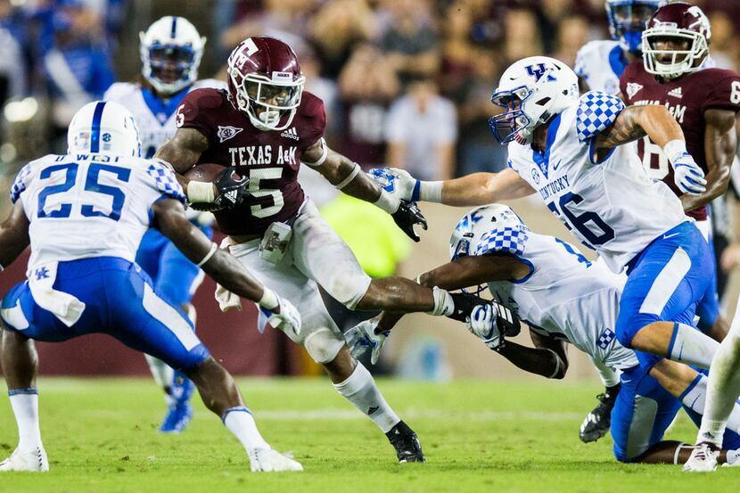 FILE - Texas A&M Aggies running back Trayveon Williams (5) is tackled by Kentucky Wildcats...
