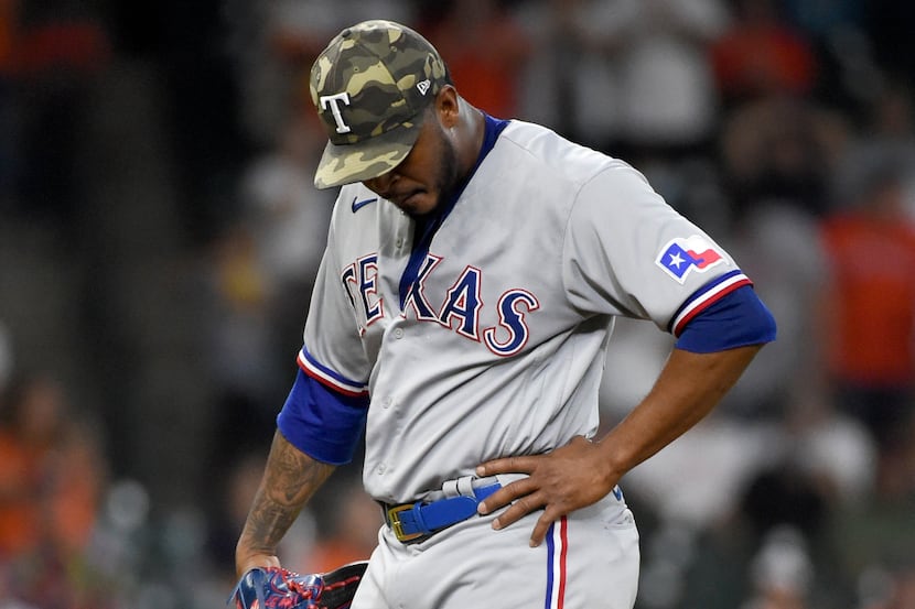 Texas Rangers relief pitcher Joely Rodriguez reacts after giving up a two-run single during...