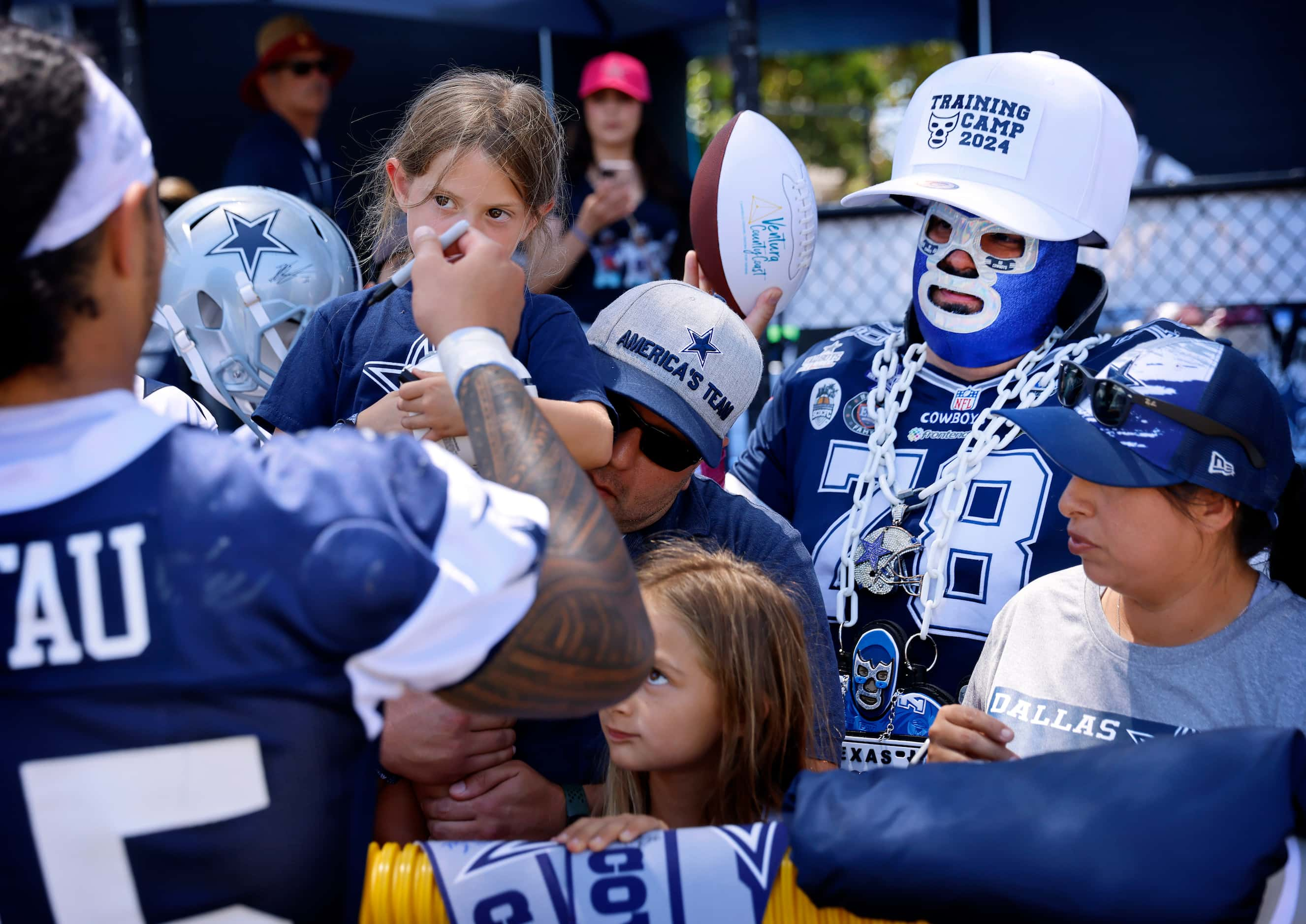 Dallas Cowboys Super Cowboy Miguel Castellanos of Grand Prairie, Texas (right, with big cap)...