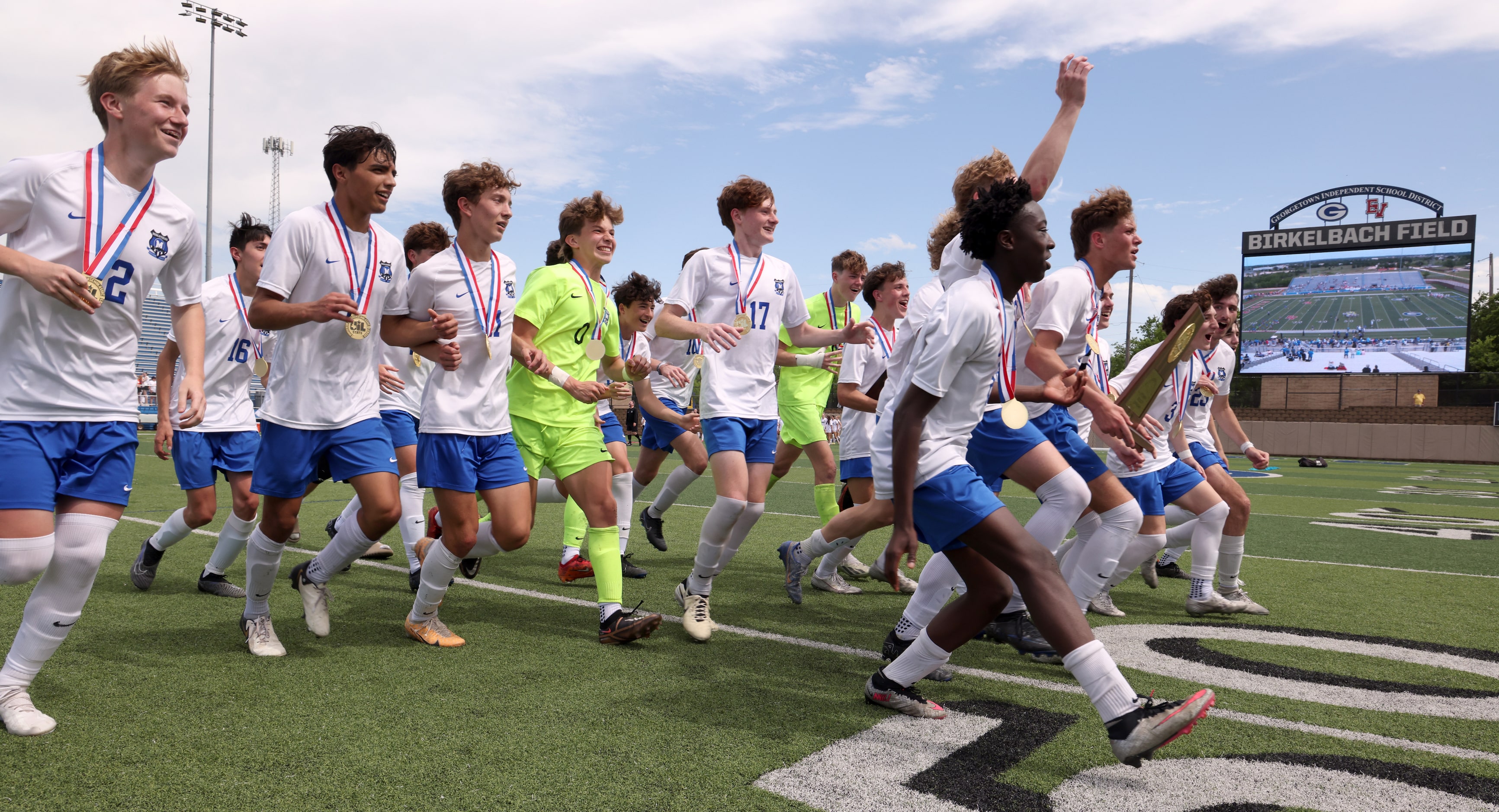 Midlothian players race to greet cheering fans in the stands after receiving their state...