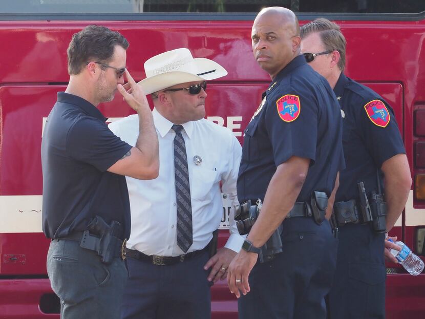 Denton Police Chief Frank Dixon (second from right) talked with other law enforcement...