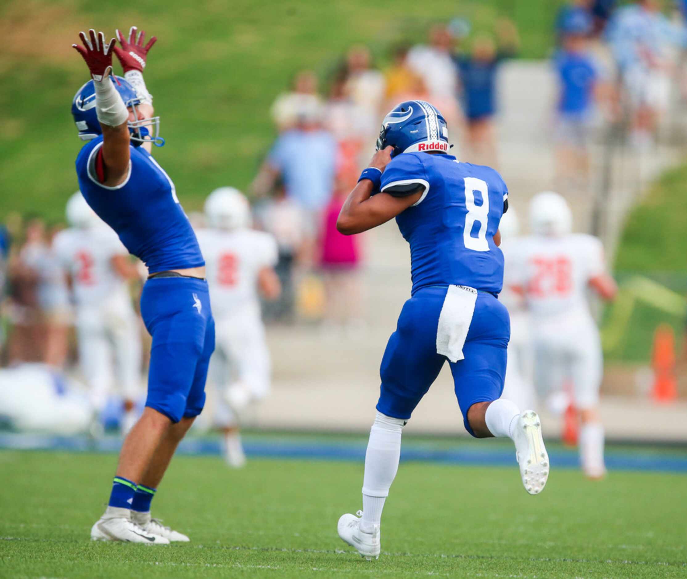 Nolan Catholic tight end Noah Petty (right) celebrates with defensive back Spencer Roof (8)...