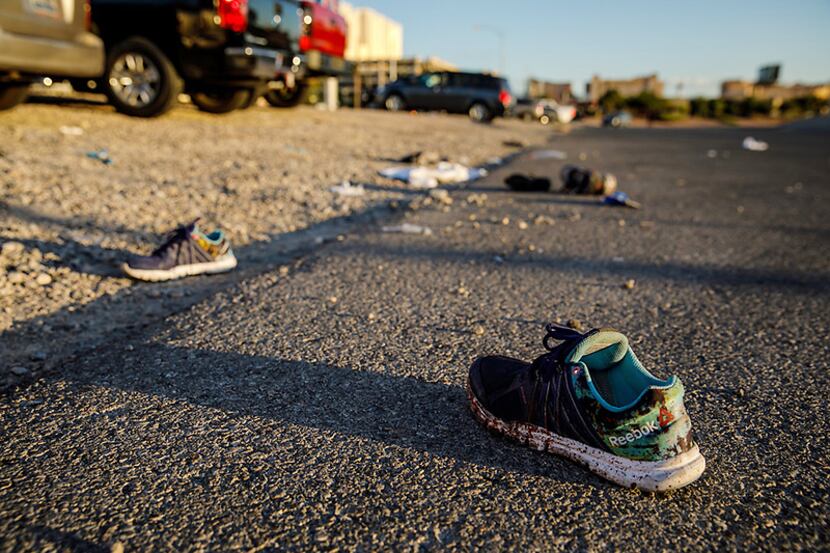 Discarded personal items, some covered in blood, litter Kovaln Lane Monday in Las Vegas...