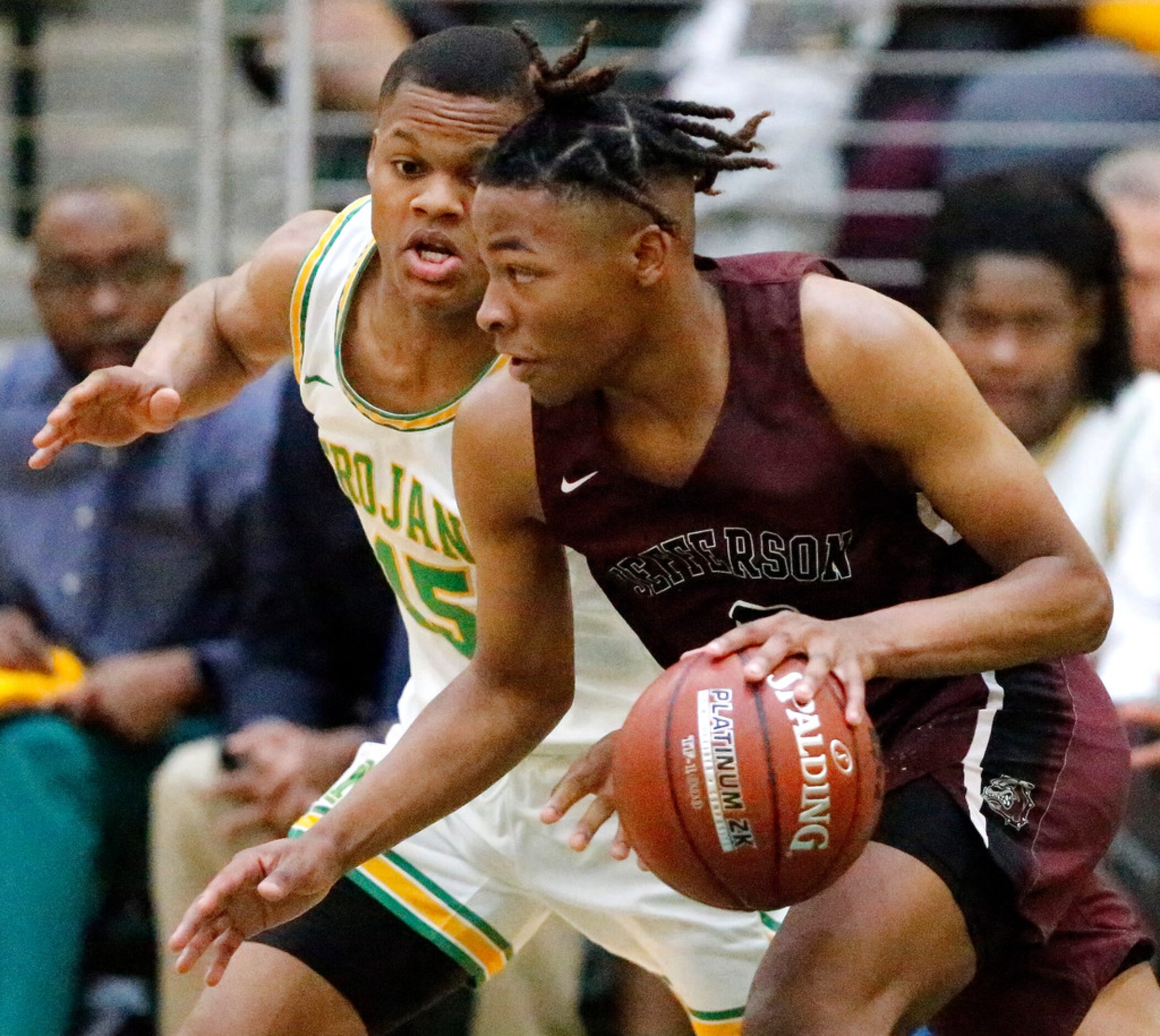 Jefferson High School guard Jakardan Davidson (0) is defended by Madison High School forward...