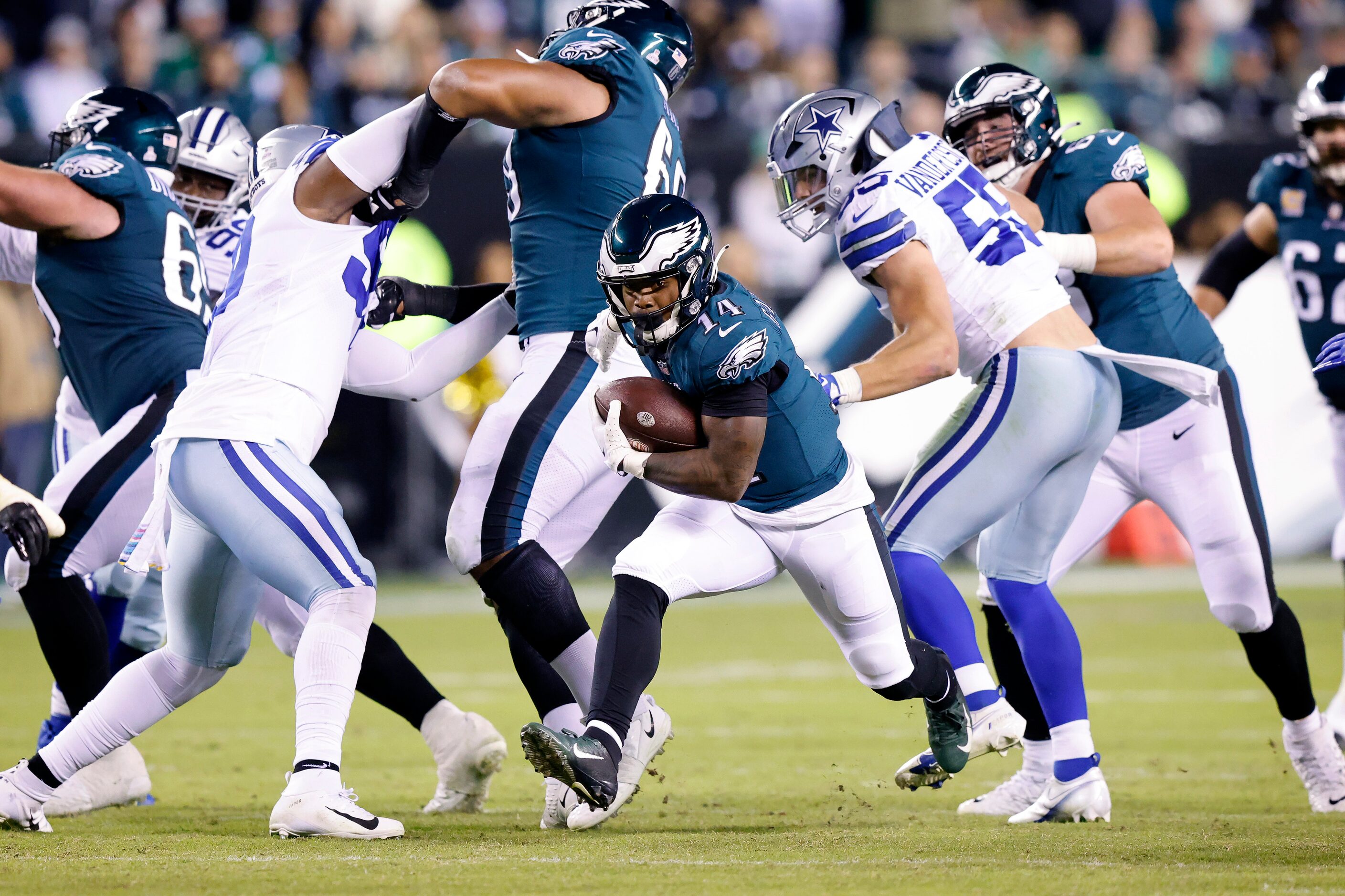 Philadelphia Eagles running back Kenneth Gainwell (14) breaks through the Dallas Cowboys...