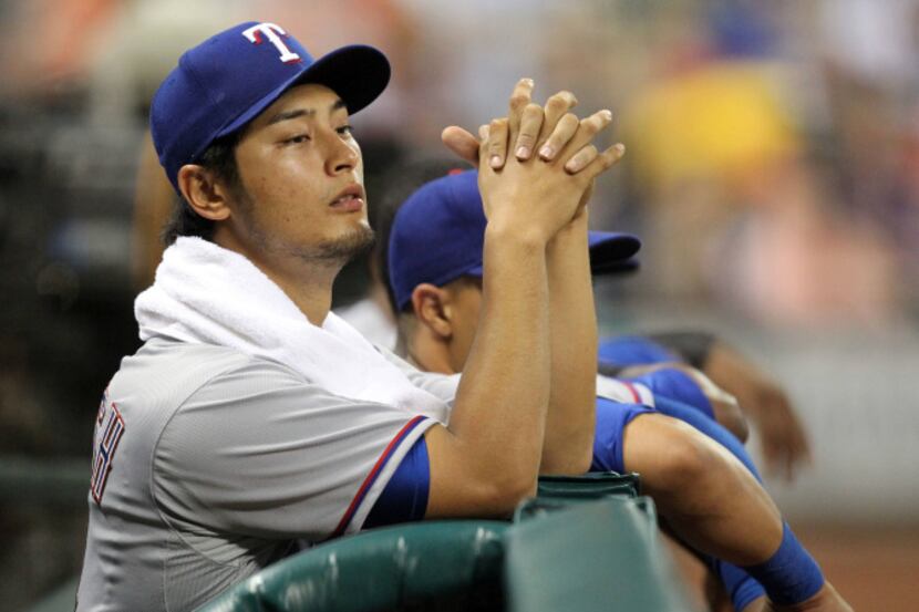 Texas pitcher Yu Darvish watches the action from the dugout in the sixth inning during the...