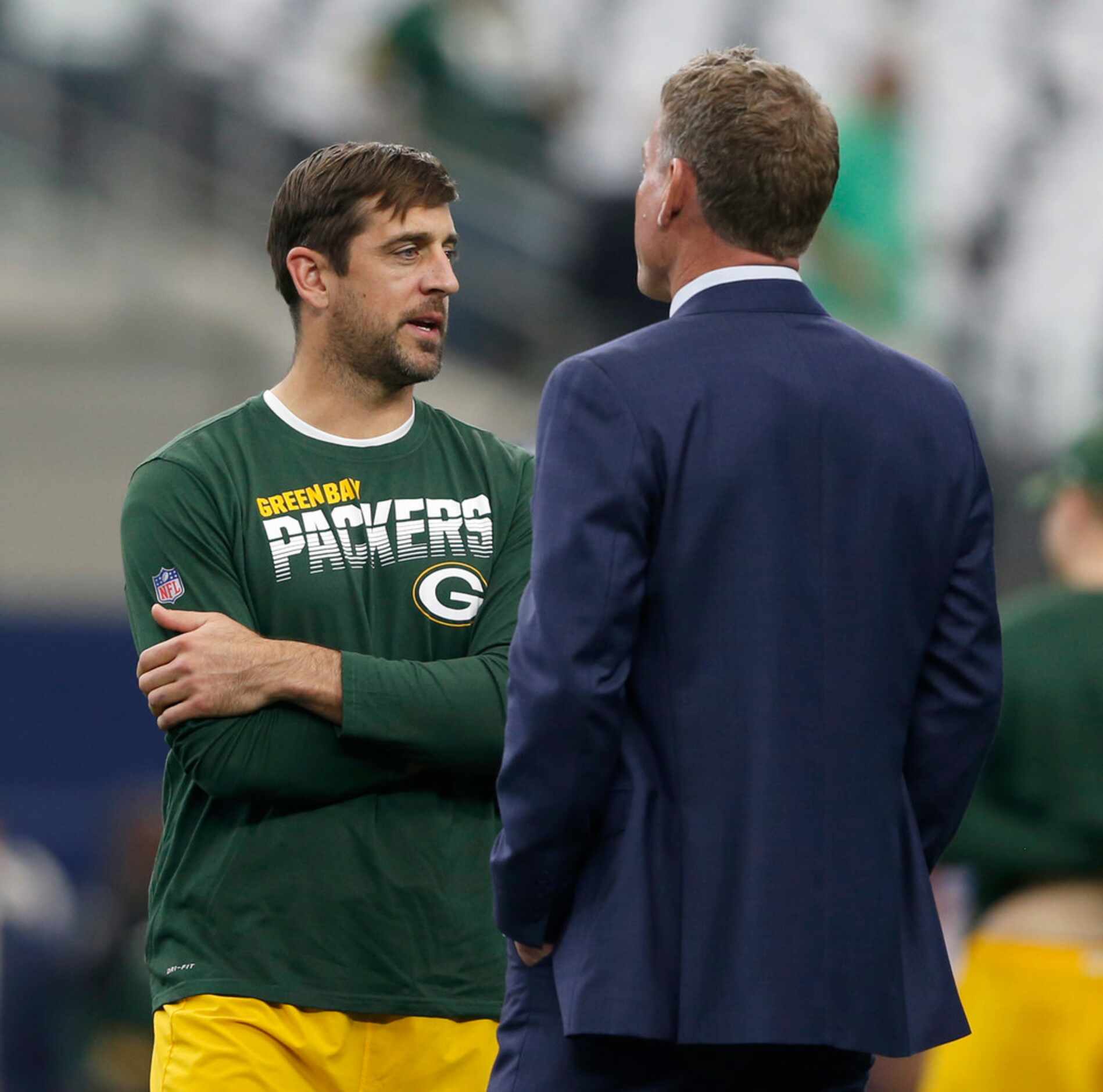 Green Bay Packers quarterback Aaron Rodgers (12) talks with former Dallas Cowboys...