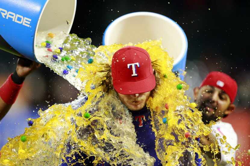 Texas Rangers starting pitcher A.J. Griffin (center) received the gum ball, water, and...