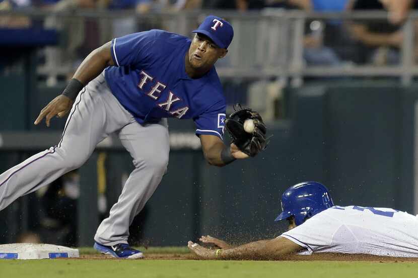 Kansas City Royals' Justin Maxwell is caught stealing third by Texas Rangers third baseman...