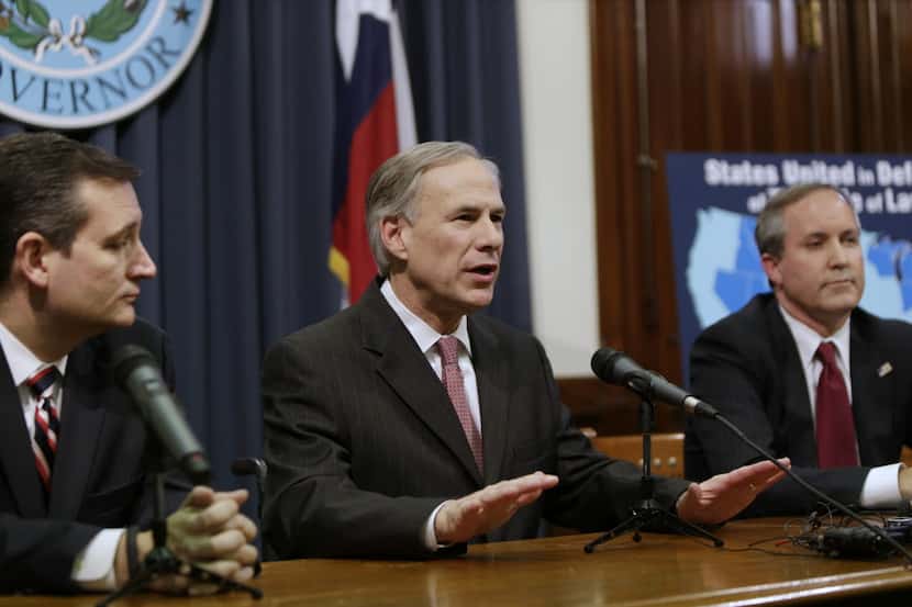  Governor Greg Abbott, center, speaks at a Capitol news conference on February 18, 2015 in...