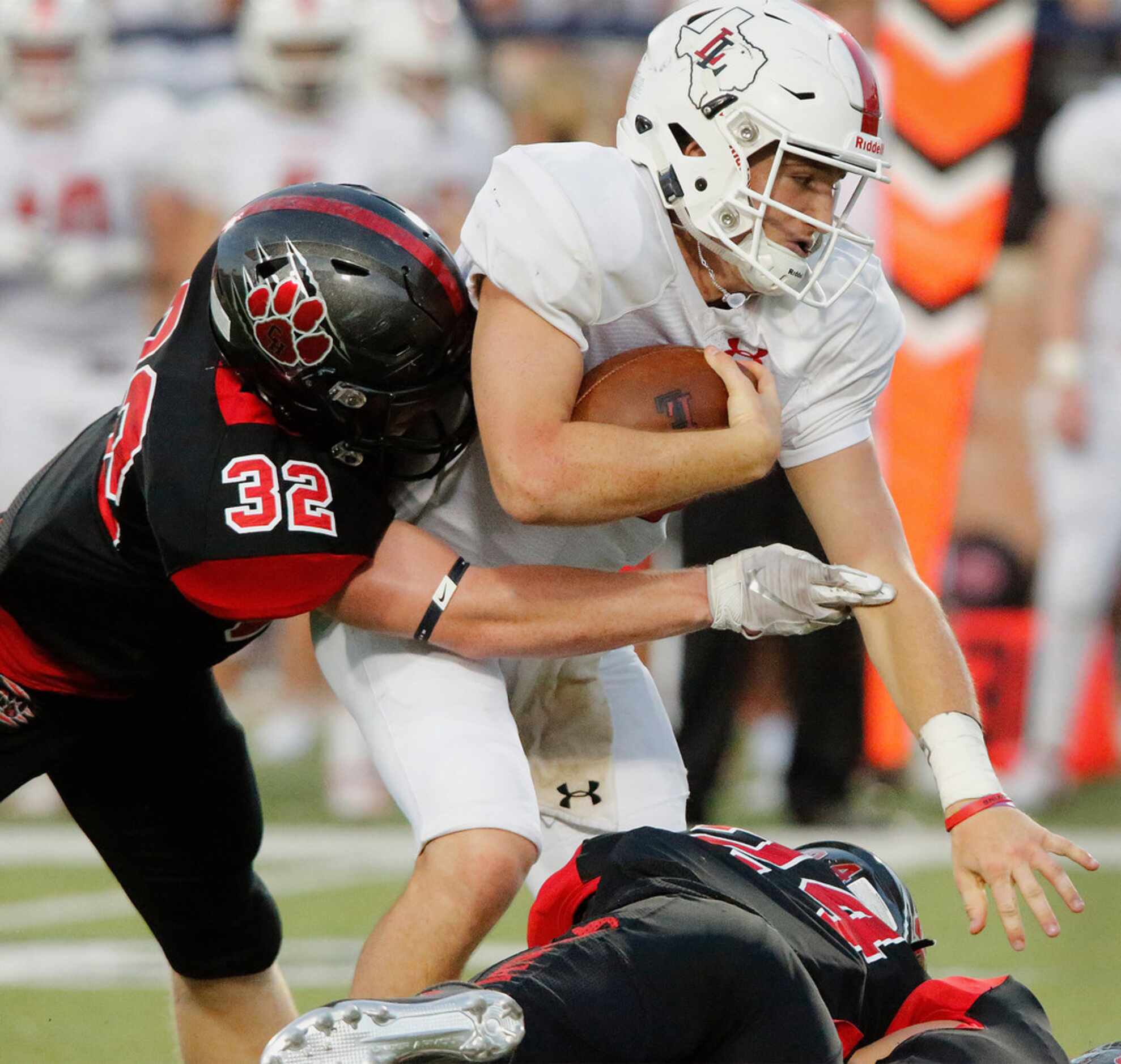 Lovejoy High School quarterback Ralph Rucker (10) is tackled by Colleyville Heritage High...